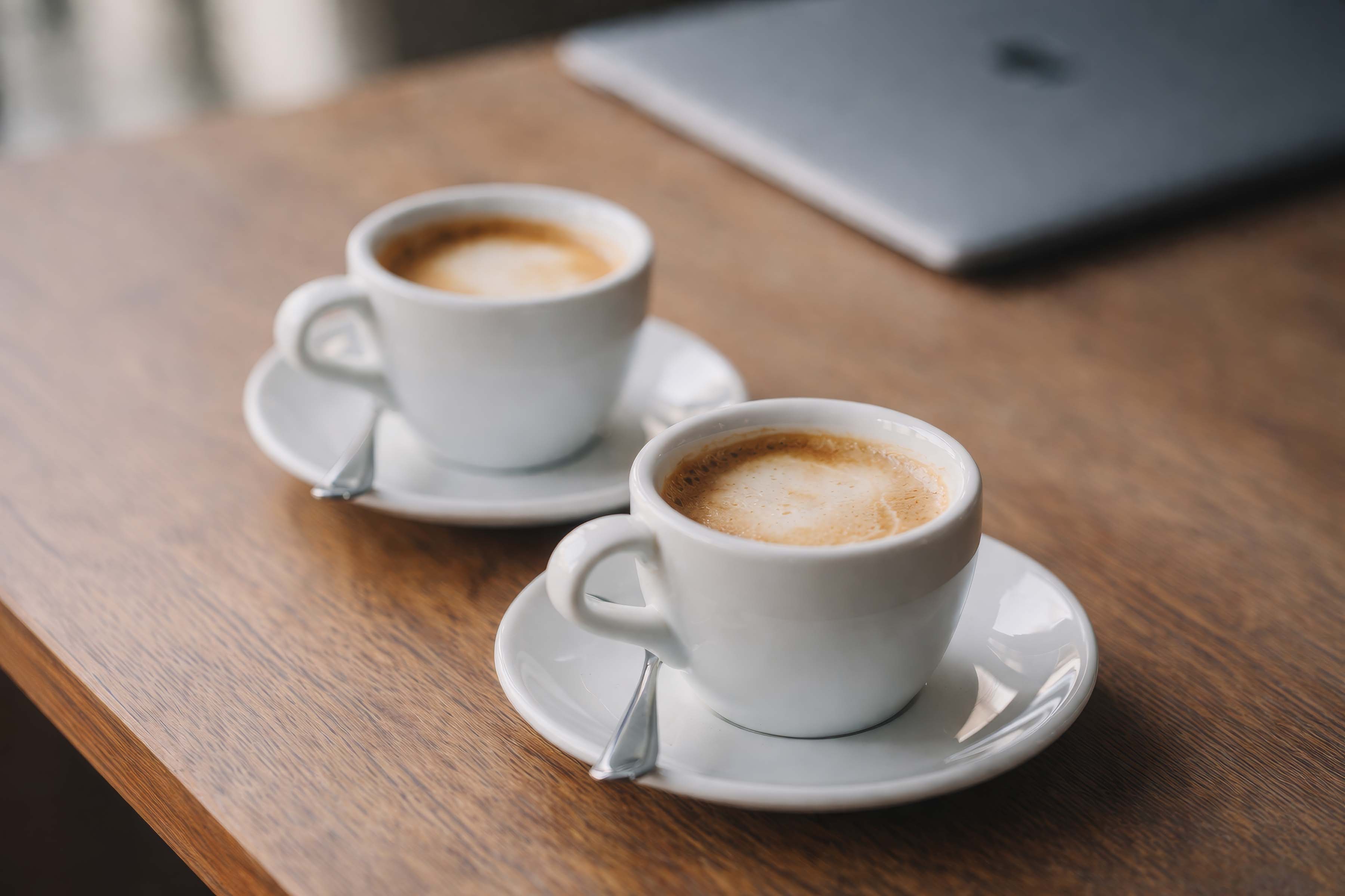 Two cups of coffee on a table during an informal discussion
